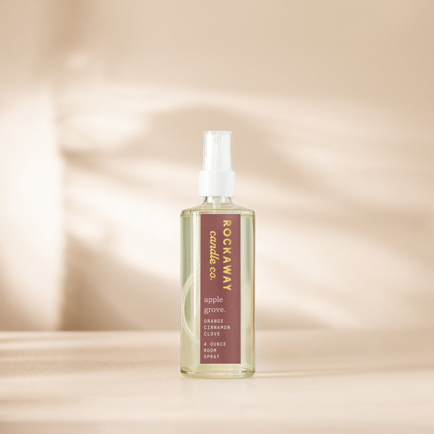 Spray bottle with 'Rockaway Candle Co.' branding on a beige background